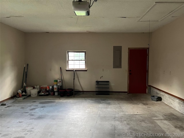 garage featuring electric panel and a garage door opener