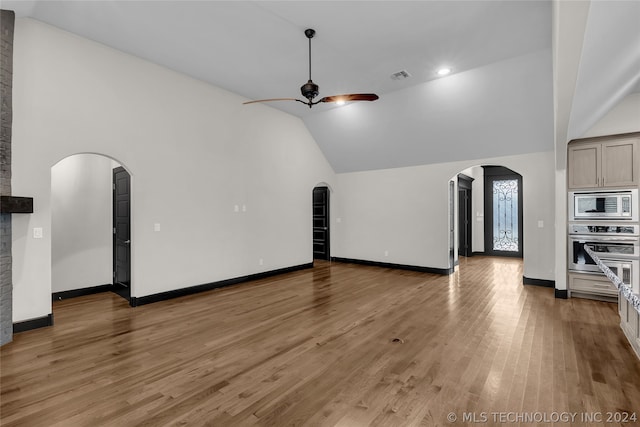 unfurnished living room featuring high vaulted ceiling, ceiling fan, and wood-type flooring