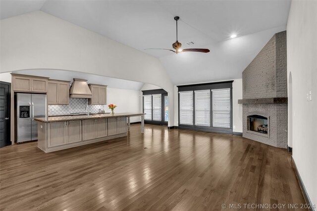 kitchen with ceiling fan, decorative backsplash, dark hardwood / wood-style flooring, and stainless steel refrigerator with ice dispenser