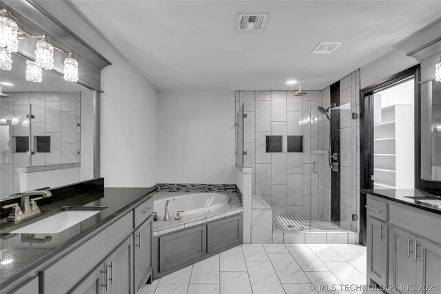 bathroom featuring vanity, shower with separate bathtub, and tile patterned flooring