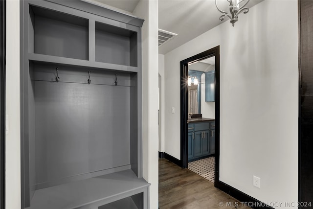 mudroom featuring sink and dark wood-type flooring