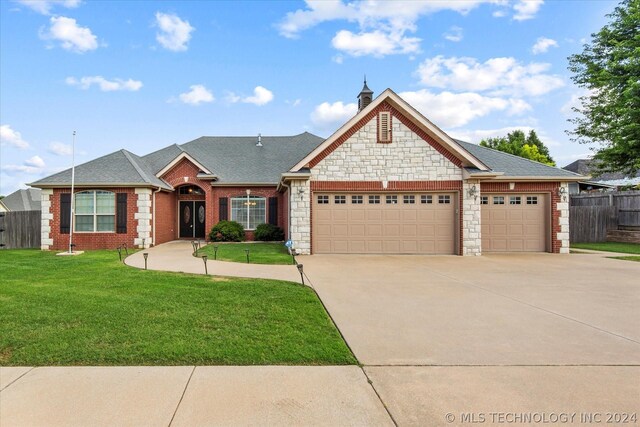 view of front of home featuring a garage and a front lawn