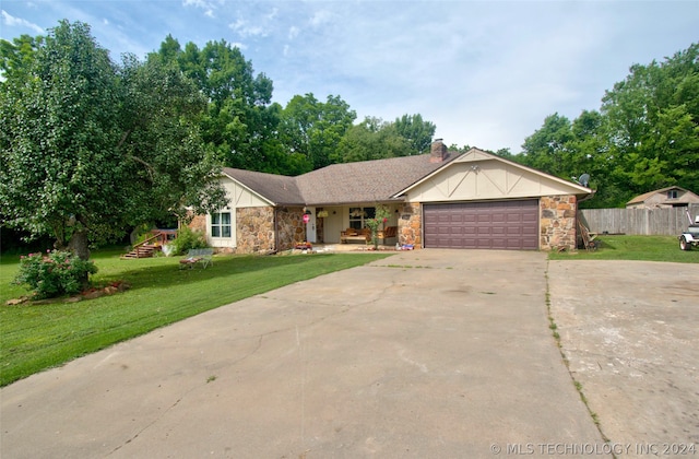 single story home featuring a garage and a front yard