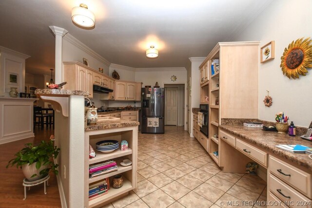 kitchen with built in desk, oven, a kitchen bar, kitchen peninsula, and stainless steel refrigerator with ice dispenser