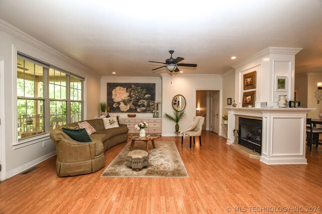 living room with ornamental molding and light wood-type flooring