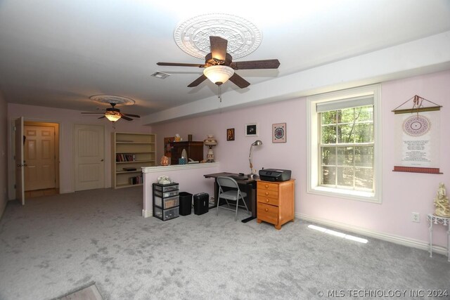 carpeted office with ceiling fan