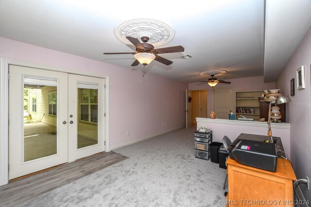 unfurnished living room featuring light carpet and french doors