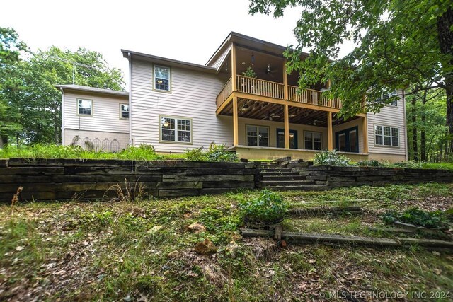 back of property with a balcony