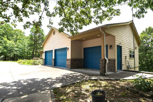 view of side of home featuring a garage