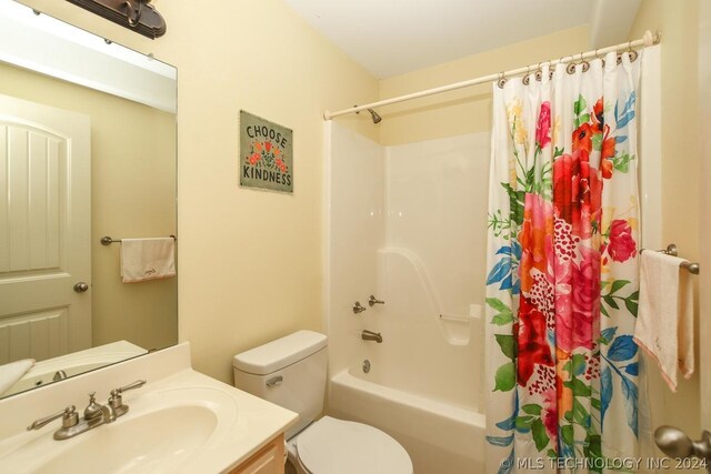 full bathroom with vanity, shower / bathtub combination with curtain, and toilet