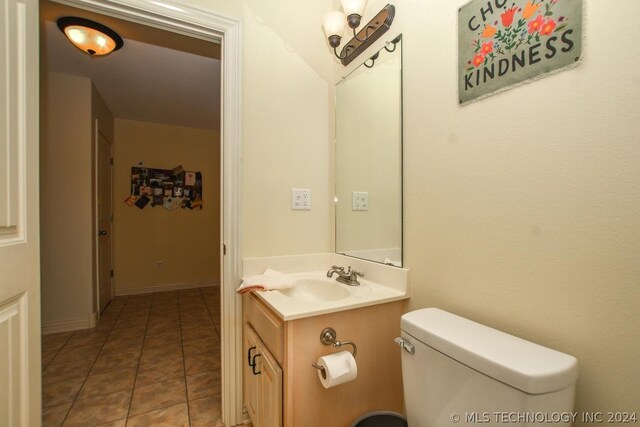 bathroom with vanity, toilet, and tile patterned flooring