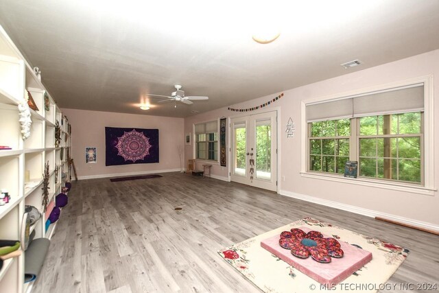 interior space with wood-type flooring and ceiling fan