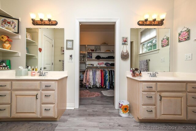 bathroom with hardwood / wood-style flooring and vanity