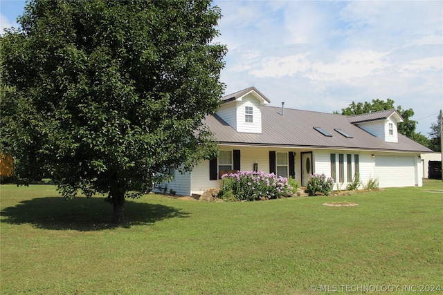 cape cod house with metal roof, a front lawn, a porch, and an attached garage