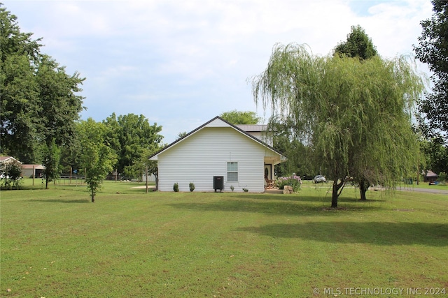 view of property exterior featuring a lawn