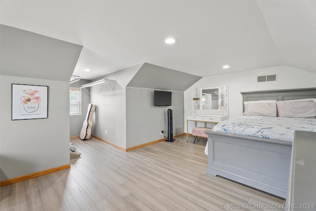 bedroom with light hardwood / wood-style floors and vaulted ceiling