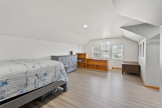 bedroom featuring vaulted ceiling and light wood-type flooring