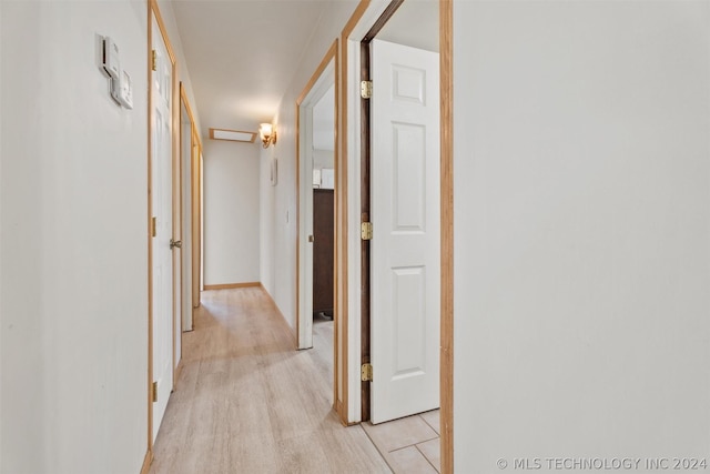 hallway with light hardwood / wood-style flooring