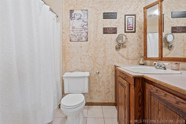 bathroom with tile patterned flooring, vanity, and toilet