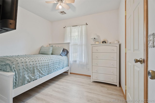 bedroom with ceiling fan and light wood-type flooring