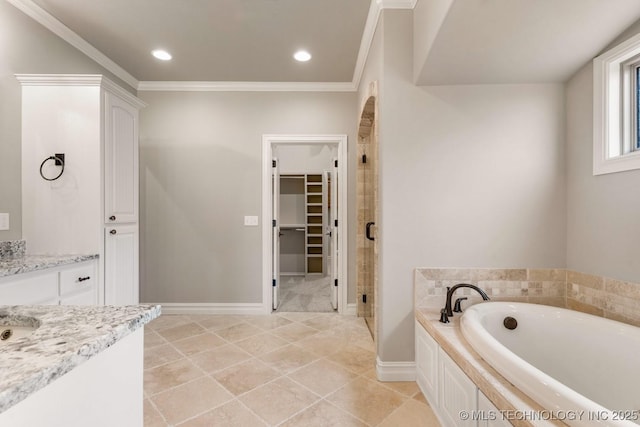 bathroom featuring baseboards, a garden tub, a spacious closet, crown molding, and a shower stall