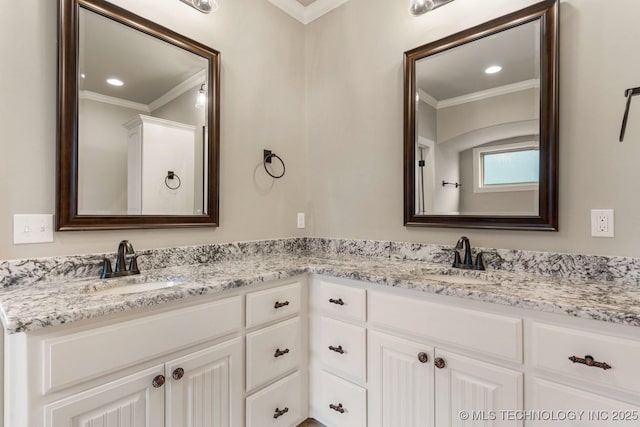 bathroom with double vanity, ornamental molding, and a sink