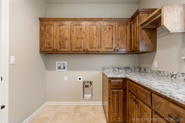 washroom with cabinet space, hookup for a washing machine, baseboards, and hookup for an electric dryer