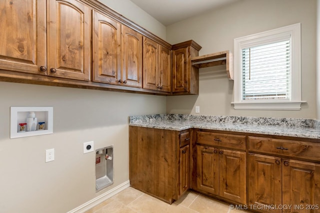 washroom featuring light tile patterned floors, hookup for a washing machine, hookup for an electric dryer, baseboards, and cabinet space