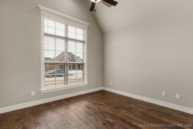 empty room with lofted ceiling, a ceiling fan, baseboards, and dark wood-type flooring