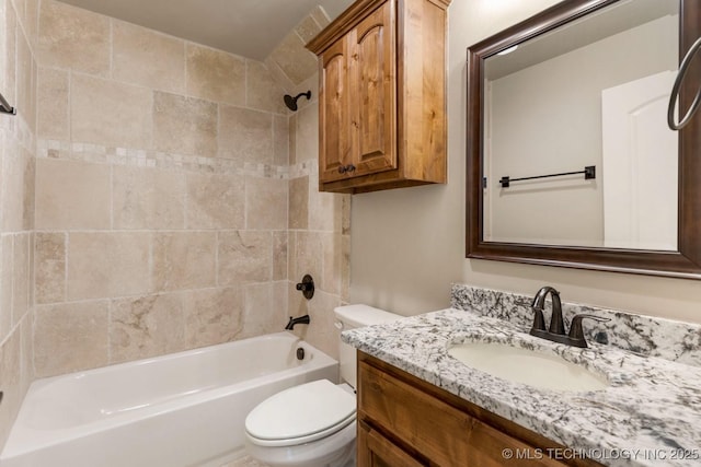 bathroom with toilet,  shower combination, and vanity