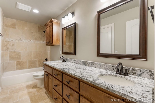 bathroom with toilet, double vanity, a sink, and shower / bathtub combination