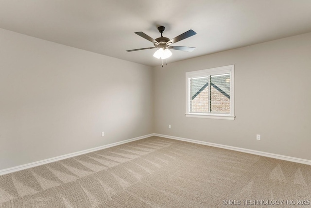 unfurnished room with baseboards, ceiling fan, and light colored carpet