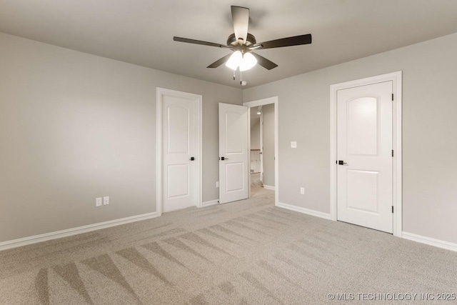 unfurnished bedroom featuring carpet, ceiling fan, and baseboards