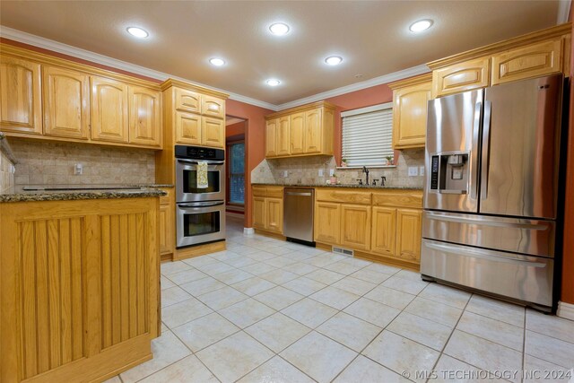 kitchen with crown molding, tasteful backsplash, light tile patterned flooring, light stone counters, and stainless steel appliances