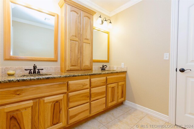 bathroom with crown molding, tile patterned flooring, and vanity