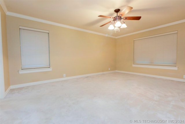 carpeted empty room with ceiling fan and ornamental molding