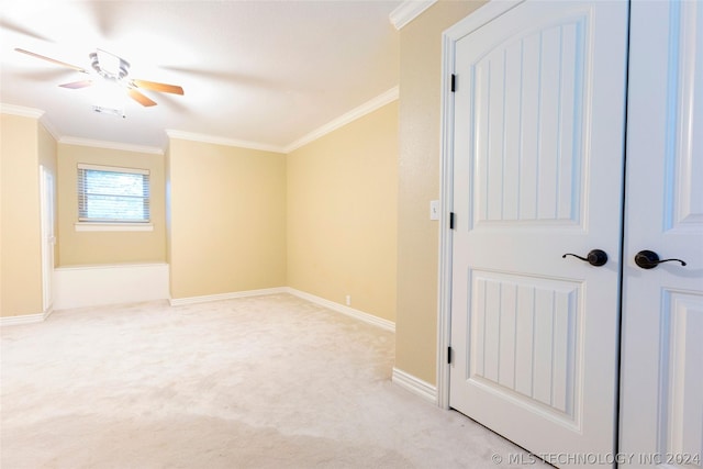 interior space with ceiling fan and ornamental molding