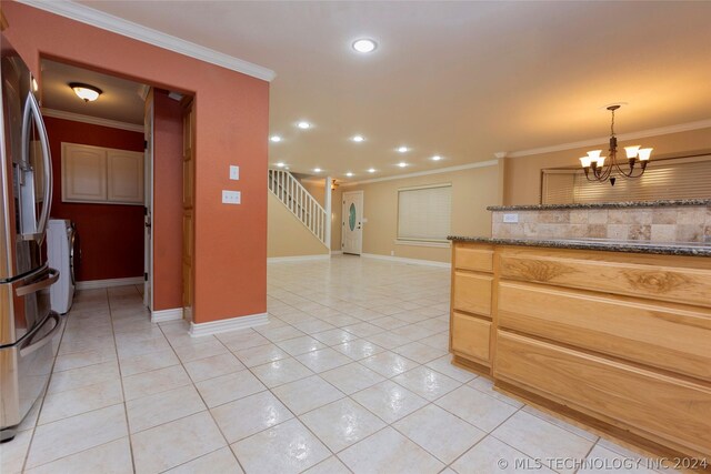 kitchen featuring stainless steel fridge with ice dispenser, decorative light fixtures, light tile patterned floors, and crown molding