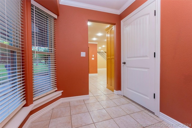 corridor featuring light tile patterned flooring and ornamental molding