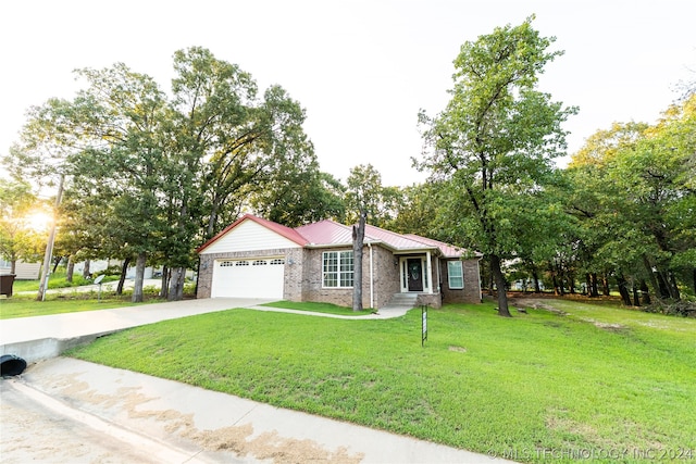 single story home with a garage and a front lawn