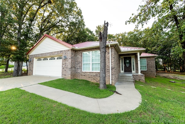 single story home featuring a garage and a front yard