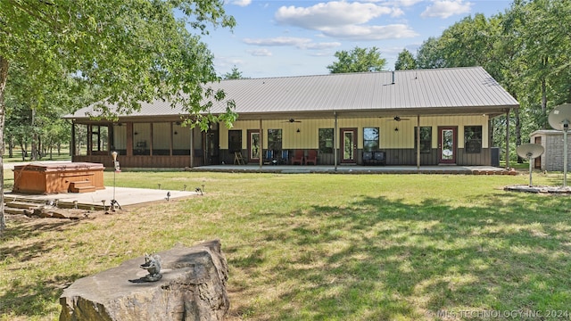 rear view of property with french doors, a patio area, a lawn, ceiling fan, and a hot tub