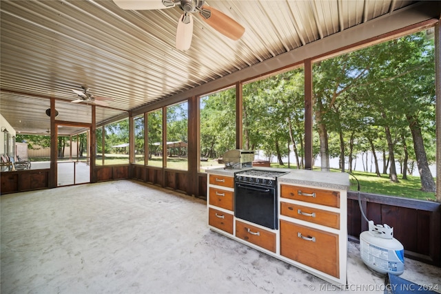 view of patio with an outdoor kitchen and ceiling fan