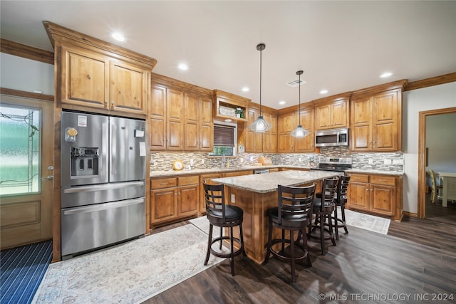 kitchen featuring a center island, backsplash, dark wood-type flooring, stainless steel appliances, and pendant lighting