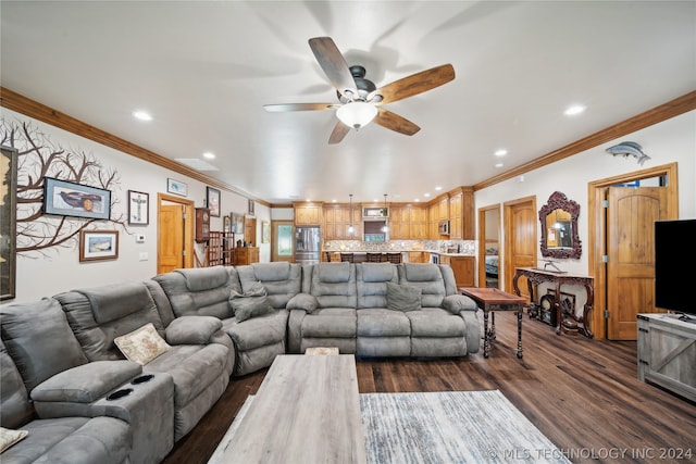 living room with ornamental molding, ceiling fan, and dark wood-type flooring