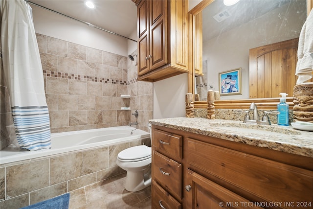 full bathroom featuring shower / bath combo with shower curtain, vanity, tile patterned floors, and toilet