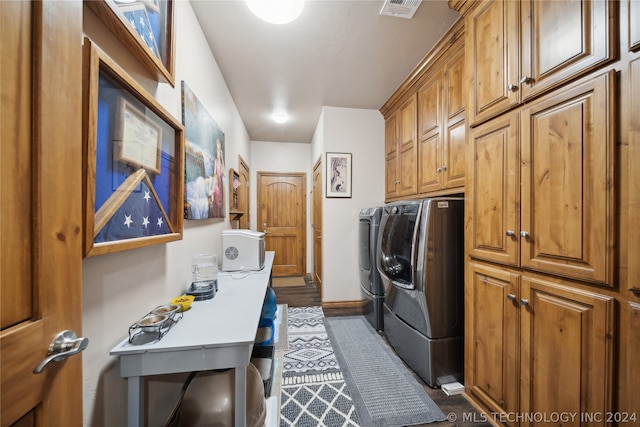 laundry room featuring cabinets, independent washer and dryer, and dark hardwood / wood-style floors