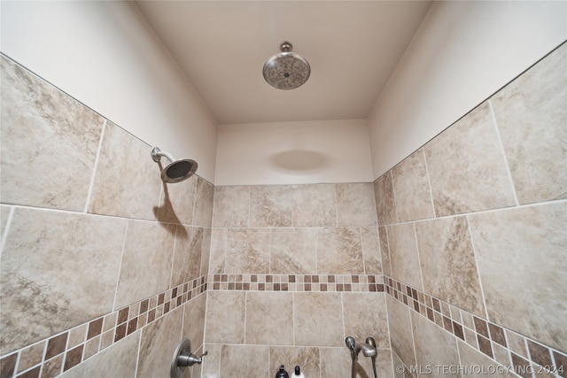 interior details with a tile shower