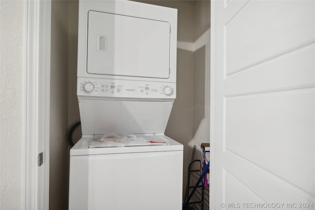 laundry room featuring stacked washer and clothes dryer