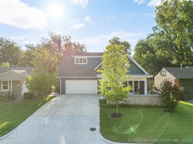 view of front of home featuring a garage, central AC, and a front yard